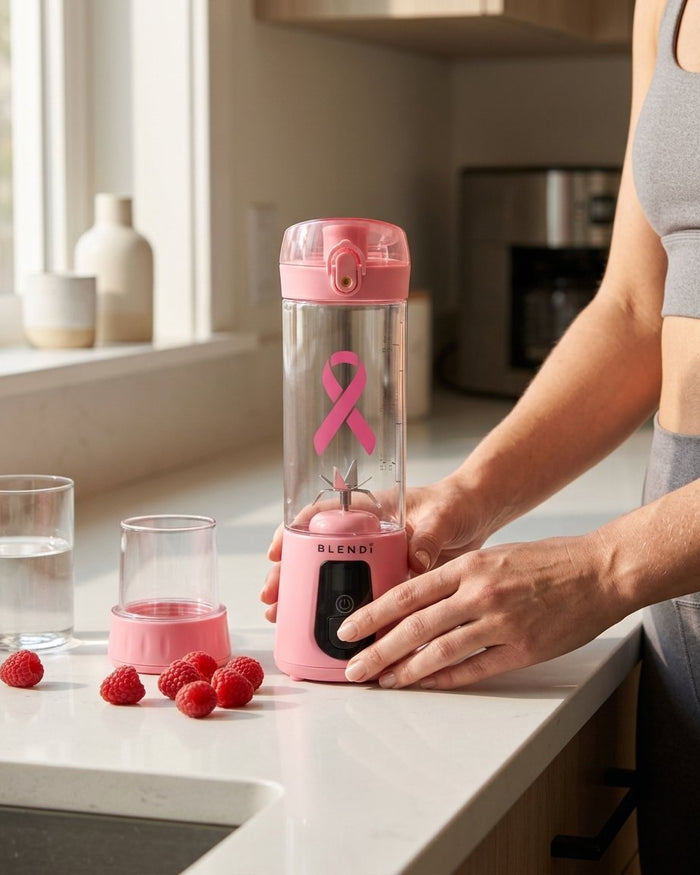 Blush BLENDi Pro+ on a kitchen counter next to fresh raspberries